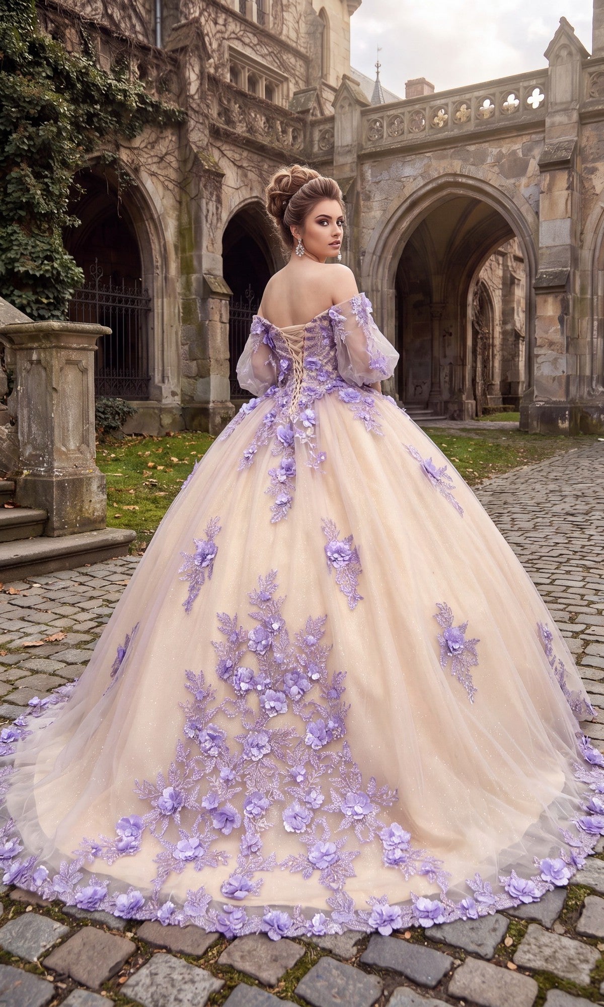 A woman wearing the Quinceanera Dress CHF3087 By Chicas—an elegant off-the-shoulder gown adorned with purple 3D floral appliqués—stands on a cobblestone path, her back to a stone building decorated with arches.